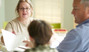 image of woman talking to a couple