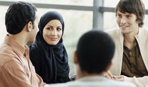 image of four people talking at a table