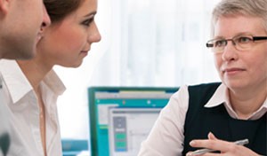 image of woman talking to two other people