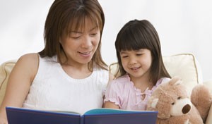 image of woman reading a book to a child